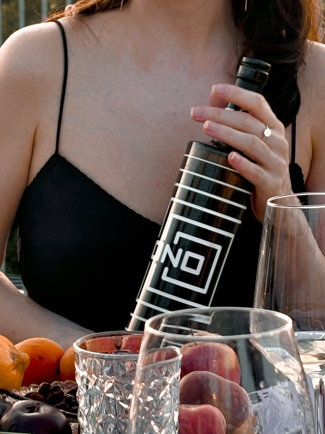 A bottle of wine held outdoors